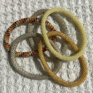 5  Sashka Co handcrafted glass bead bracelet lot. Warm colors. Appr 8”. Roll on.